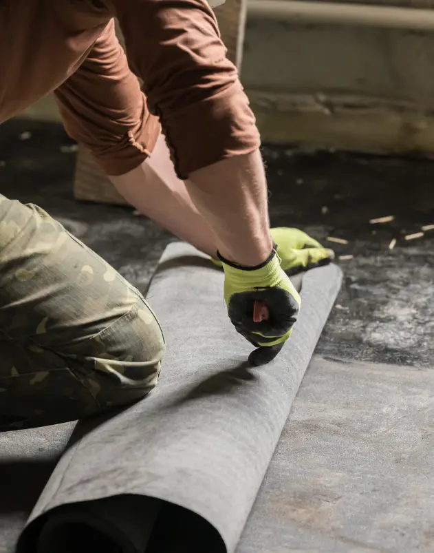 Man working on waterproofing basement in a house.